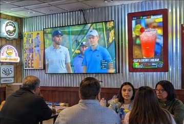 Customers seated near a URTVS screen